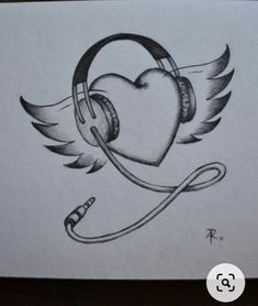 a drawing of headphones with wings and a heart in the middle, on top of a piece of paper