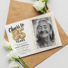 Elegant adult 85th birthday party invitations featuring a simple white background that can be changed to any color, a photo of the birthday girl / boy, gold sparkly glitter, gold hellium balloons, and a modern 85th birthday celebration text template that is easy to personalize.