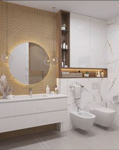 a bathroom with two toilets, a sink and a large mirror on the wall above it