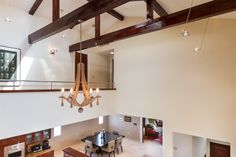 an overhead view of a dining room and living room area in a house with high ceilings