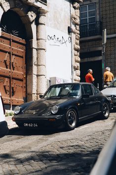 a black car parked on the side of a street