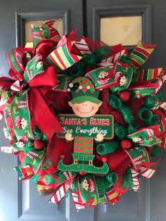 a christmas wreath with santa's elves on it