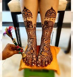 the legs and feet of a woman with henna tattoos