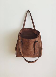 "This tote bag is made of high quality vegan leather in brown. It is soft and lightweight but durable. It stands on its own. It has a rustic, distressed look. It has one interior zipper pocket. Straps are adjustable. Measurements: 32 x 30 x 15 cm IMPORTANT! Your orders between 7-25 August will be shipped on August 28. Delivery takes 2-5 days to the US, Canada, Australia and Europe; in 3-7 days to rest of the world after shipping. For other color options you can check \"Totes\" section: http://et Brown Large Capacity Softback Bag, Dark Tan Leather Bag For On-the-go, Versatile Brown Bucket Bag For On-the-go, Brown Double Handle Shoulder Bag For Everyday, Brown Large Capacity Softback Shoulder Bag, Everyday Brown Bucket Bag, Brown Bag With Large Capacity For On-the-go, Brown Bucket Satchel For Daily Use, Brown Double Handle Bag For Everyday