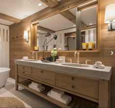 a bathroom with a tub, sink and mirror in it's centerpieces