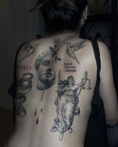 the back of a woman's body with tattoos on it