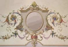 an ornate mirror is hanging on the wall