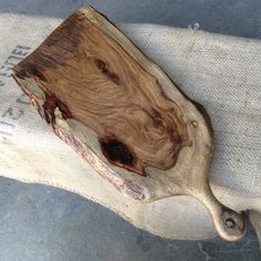 a piece of wood sitting on top of a cushion