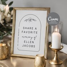 there is a framed sign on the table next to some candles and other decor items