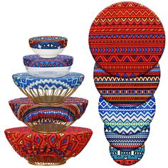 four colorful bowls stacked on top of each other in front of a white background with the same pattern