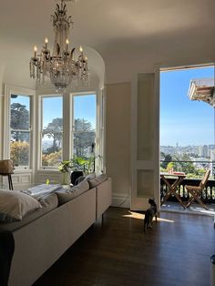 a living room filled with furniture and a chandelier