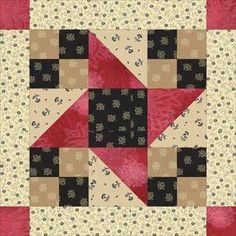 a red and black quilt with squares on it's sides, in the center