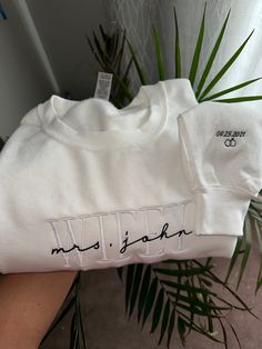 Personalized Embroidered Wife Sweatshirt | Custom last name Sweatshirt | Bridal Sweatshirt | Engagement Sweatshirt | Bride To place your order, simply select the size, style (t-shirt or sweater), and colour of the garment from the drop-down menus. Please remember to reference the size chart included in the listing photos to make sure you are ordering the correct size! Each item is handmade and packaged with love, care, and attention to detail. S T Y L E  &  F I T  >Gildan G180 - Heavy Blend™ 8 o Fitted Long Sleeve Tops With Embroidered Logo, Fitted Long Sleeve Tops With Embroidered Graphics, Fitted Crew Neck Tops With Embroidered Text, Fitted Long Sleeve Top With Custom Embroidery, White Long Sleeve Top With Custom Embroidery, White Custom Embroidery Relaxed Fit Tops, White Tops With Custom Embroidery Relaxed Fit, White Relaxed Fit Top With Custom Embroidery, Fitted Long Sleeve Embroidered T-shirt