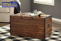 an open trunk sitting on top of a black and white checkered rug