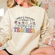 The comfortable fit and cool design of this FCS teacher sweatshirt means that it feels just as good to wear as it is to look at. If you've been looking for a cute sweatshirt for yourself, or your favorite home ec teacher, you should get this sweatshirt today. Ideal for any situation, a unisex heavy blend crewneck sweatshirt is pure comfort. These garments are made from polyester and cotton. This combination helps designs come out looking fresh and beautiful. The collar is ribbed knit, so it retains its shape even after washing. There are no itchy side seams on these sweatshirts. .: 50% Cotton 50% Polyester .: Medium-heavy fabric (8.0 oz/yd² (271.25 g/m .: Loose fit .: Sewn in label .: Runs true to size ✈ PROCESSING & SHIPPING ✈ Processing Time: 1-2 weeks. (usually 1-3 days) Standard Shippi White Relaxed Fit Top For Teaching, Casual Relaxed Fit Tops For Teaching, Casual Long Sleeve Tops For Back To School, Long Sleeve Cotton Top For Back To School, Casual Long Sleeve T-shirt For End Of School Year, Back To School Long Sleeve Cotton Top, Top Teacher Gifts, Gifts For Teacher, First Day Of School Shirt