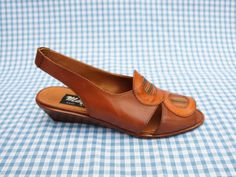 "These shoes are previously unworn ex shop stock from the 1980s. They were handmade in Italy and have been made from genuine Italian leather. They have a small wedge heel, a slingback strap at the back and a leatherwork circle pattern on the front. They are very good quality \"Mayfair\" shoes and they come in their original box. They are beautifully made and look beautiful when worn. The heel height is 4cm. The shoes are slightly smaller than modern sizing in my experience - please get in touch for more detailed measurements! As these shoes are unsold vintage shop stock, they come in a variety of sizes. Please see the drop-down list to the right for available sizes." Retro Slingback Summer Sandals, Retro Slingback Sandals For Summer, Retro Leather Sandals With Low Heel, Vintage Brown Low Heel Sandals, Vintage Brown Sandals With Low Heel, Retro Formal Sandals For Summer, Retro Formal Summer Sandals, Vintage Open Heel Wedge Sandals For Summer, Brown Retro Wedge Sandals For Summer