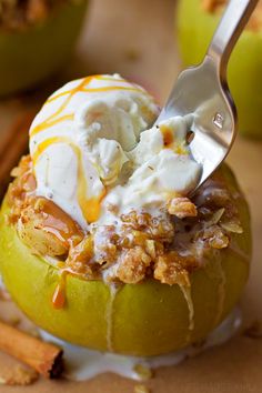 an apple with some ice cream and cinnamon sticks