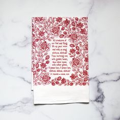 a red and white napkin with a poem printed on it sitting on a marble surface