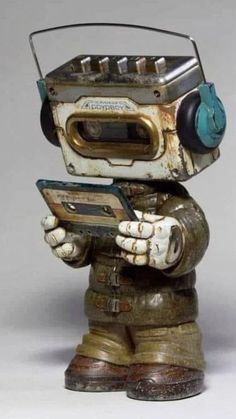 an old fashioned robot with headphones on holding a cell phone