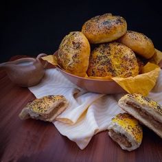 a bowl filled with pastries sitting on top of a table next to a napkin