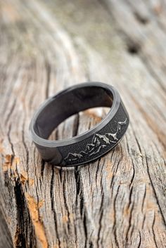 a black ring sitting on top of a wooden table