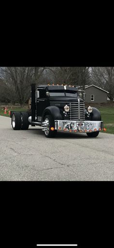 a large black truck parked on the side of a road