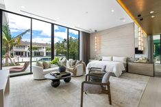 a living room filled with furniture and large windows