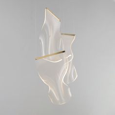 two suspended lights in the shape of abstract shapes