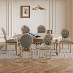 a dining room table with six chairs and an open book on the table in front of it