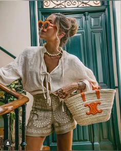 a woman wearing sunglasses and holding a basket