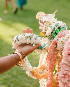 a woman is placing flowers on a wreath