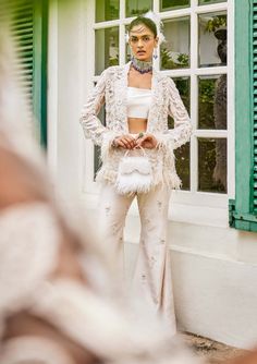 Make a bold fashion statement with this exquisite ensemble. A feather jacket, adorned with intricate white resham, sequins, cutdana, and crystal tassels, takes center stage. Paired with a stylish bustier and embroidered pants, this set is the epitome of sophistication and glamour, perfect for a glamorous event. Feather Jacket, Embroidered Pants, Lily White, White Feather, Dupion Silk, Satin Color, White Feathers, Bell Bottom Pants, Silk Embroidery