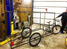 a man standing next to a bike in a garage