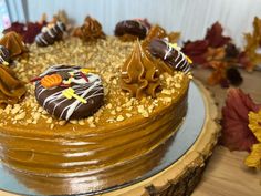 a cake with chocolate frosting and candy decorations on it's top is sitting on a table