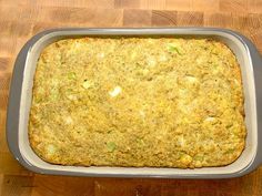 a casserole dish is sitting on a wooden table