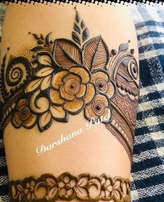 a woman's legs with henna tattoos on it