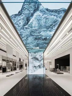 the interior of a store with mountains painted on the wall and flooring in black and white