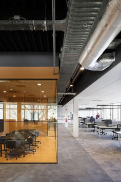 an empty conference room with glass walls and chairs