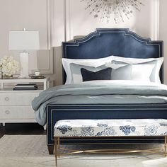 a blue bed with white sheets and pillows