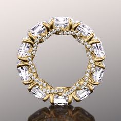 A design that entices you to indulge. This ring features a presentation of oval diamonds circling the band's circumference. Each oval diamond is securely cradled by claw prongs on a u-shaped setting. Crossing over the concave setting, and visible from the ring's sides, are ribbons of round diamonds for full coverage sparkle. Luxury Infinity Diamond Ring With Brilliant Cut, Oval Eternity Band With Prong Setting For Formal Occasions, Luxury Oval Eternity Band With Diamond Accents, Oval Diamond Eternity Band In Fine Jewelry Style, Oval Diamond Eternity Band Fine Jewelry, Oval Diamond White Eternity Band With Diamond Accents, Oval Diamond Eternity Band With Prong Setting, Oval Brilliant Cut Diamond Eternity Band, Oval Diamond Eternity Band With Brilliant Cut