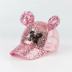 a pink baseball cap with sequins on the front and mouse ears at the peak