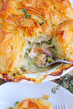 a close up of a casserole on a plate with a fork in it