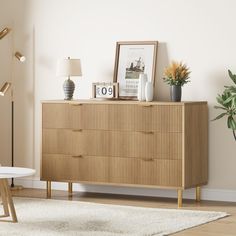 a living room scene with focus on the chest of drawers and a table in the foreground