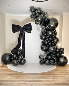 black and silver balloons are on display in the room