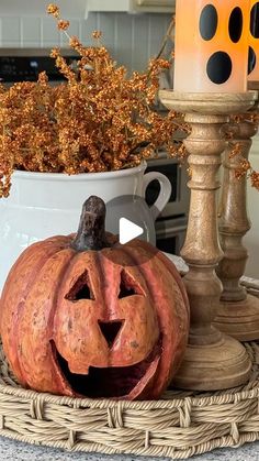 a pumpkin sitting on top of a wicker basket