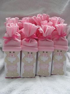 small pink and white boxes with teddy bears on them are lined up in a row