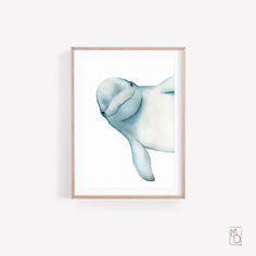 a framed print of a baby seal in blue watercolors on a white wall