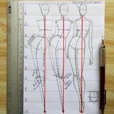 a drawing of a woman's body and measurements on a notebook with a pen