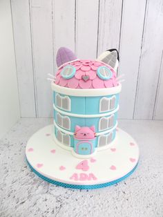 a cake that is shaped like a tower with a cat on it's top