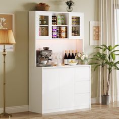 a white cabinet filled with lots of bottles next to a lamp and potted plant